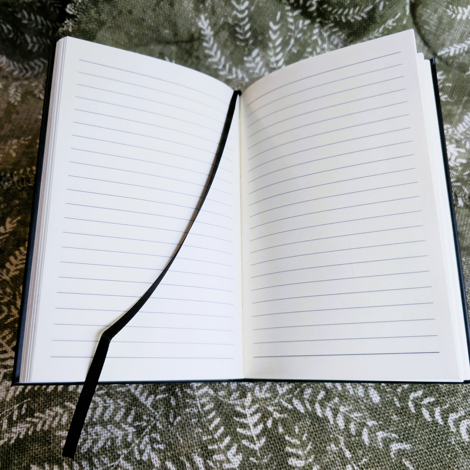 Open notebook with lined pages on a textured surface